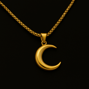 Gold crescent moon pendant on a chain against a black background