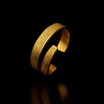 Gold bracelet with intricate designs on a black background