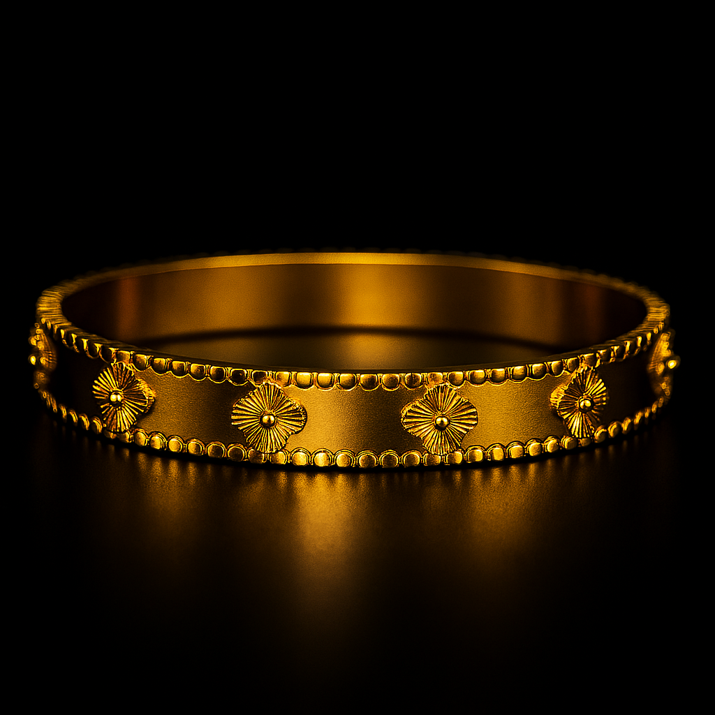 Gold bracelet with floral designs on a black background