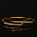 Gold bracelet with diamond accents on a black background