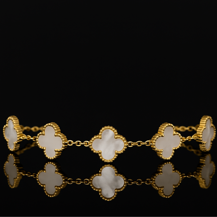 Gold bracelet with clover-shaped links on a black background